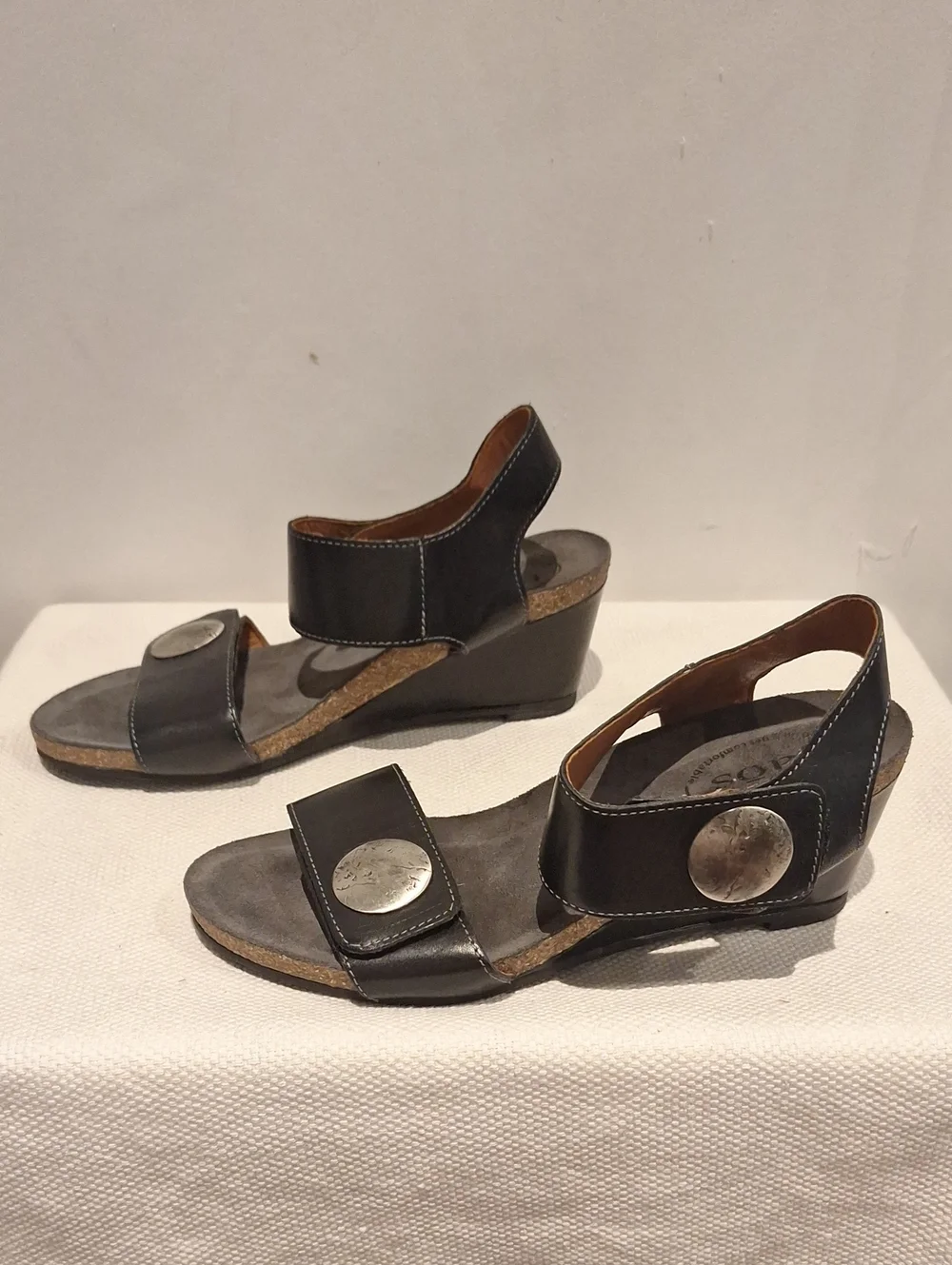 Taos Carousel 2 Black Leather Two-Strap Wedge Sandals With Silver Medalion
